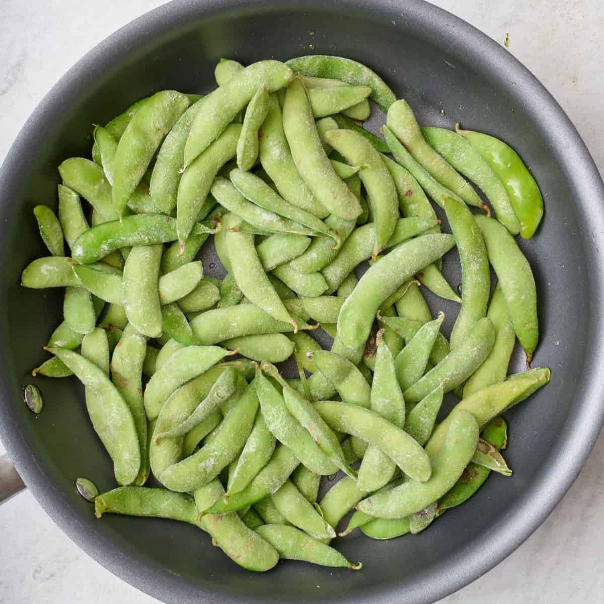Edamame in a skillet.
