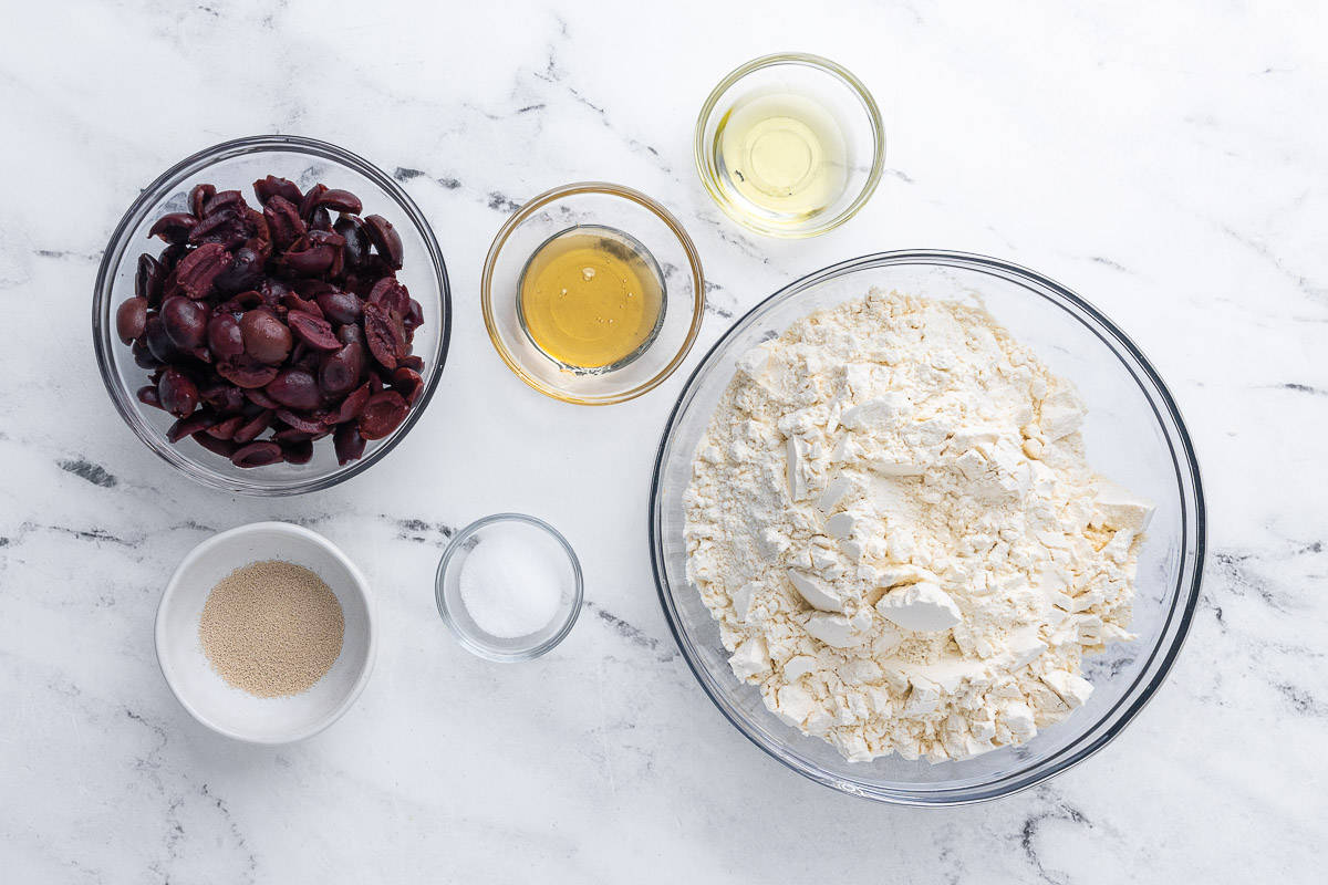Ingredients for recipe: Bread flour, yeast, salt, olive oil, honey, and kalamata olives.