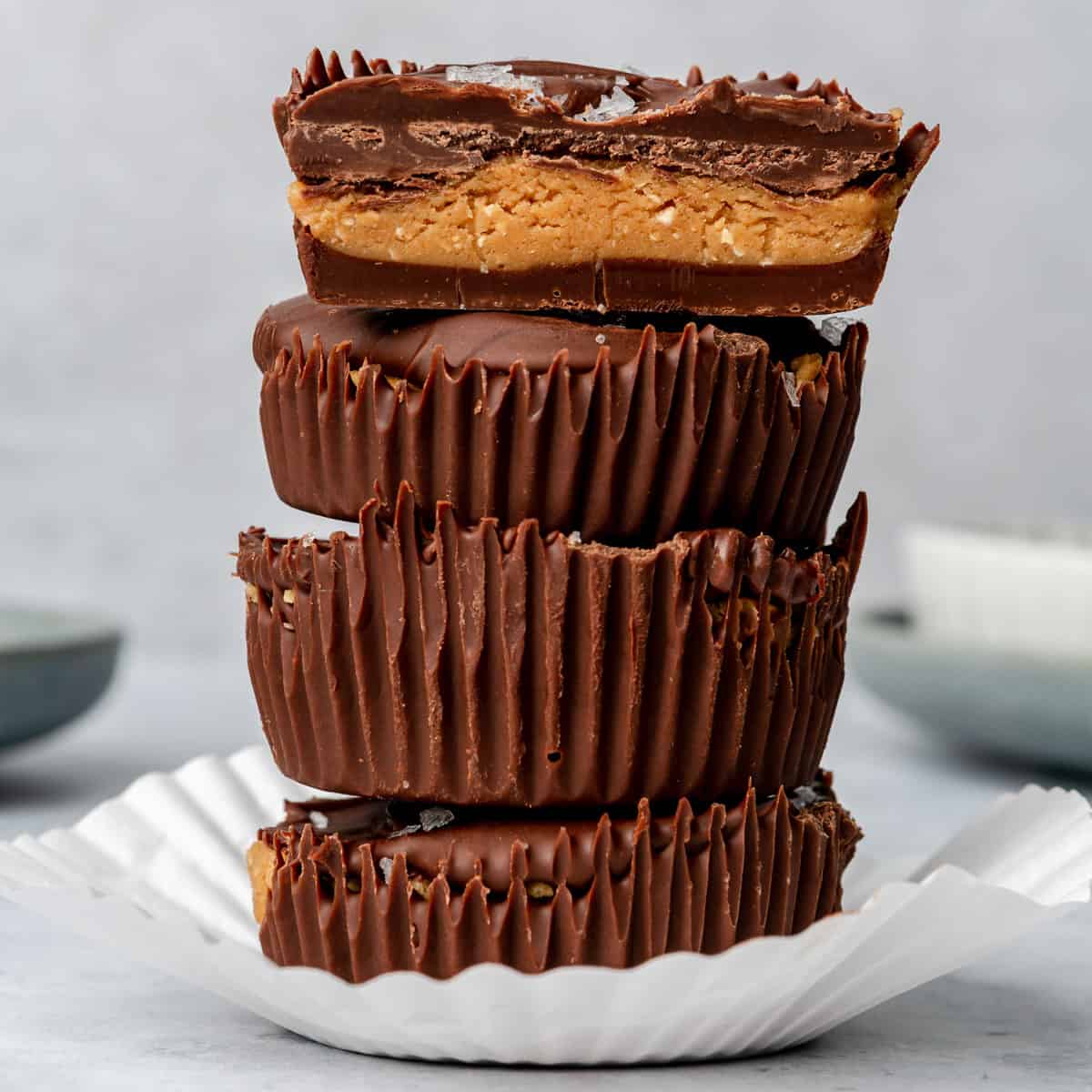 Homemade peanut butter cups stacked in a paper liner.