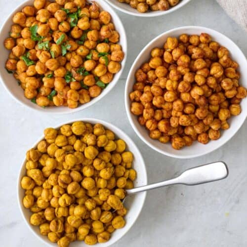 Seasoned roasted chickpeas in separate bowls.