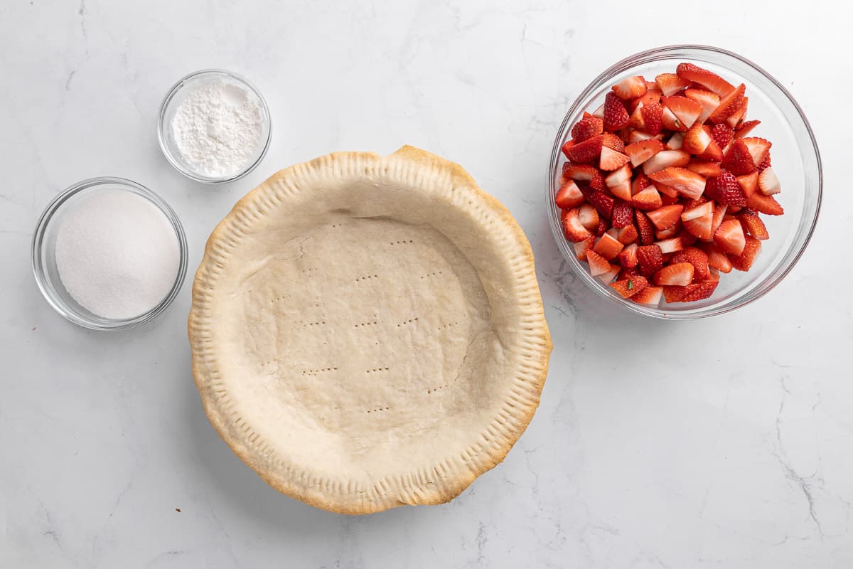 Ingredients for recipe: Store-bought pie crust, fresh strawberries, sugar, and cornstarch.