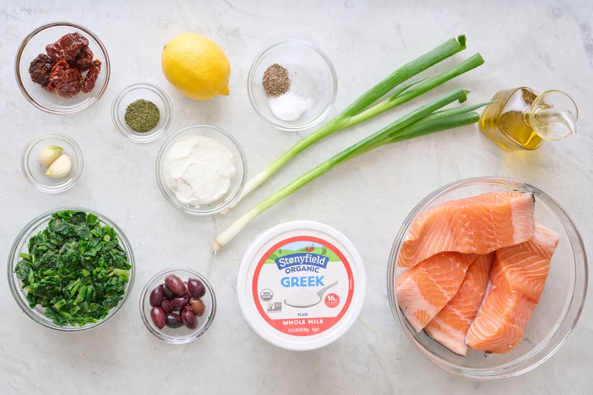 Ingredients for recipe: Salmon fillets, Stonyfield organic whole milk Greek yogurt, olive oil, sun-dried tomatoes, spinach, Kalamata olives, garlic, green onions, dried dill, salt, and black pepper.