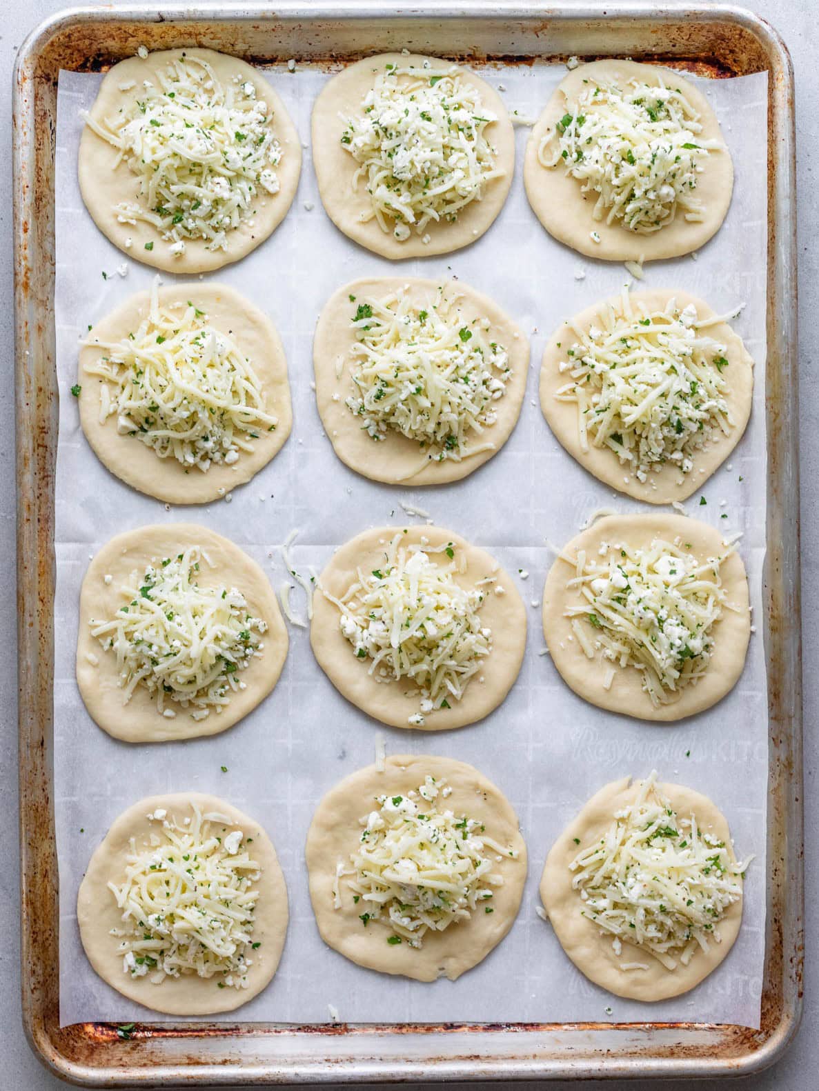 Dough rolled out into small circles, with filling added to each.