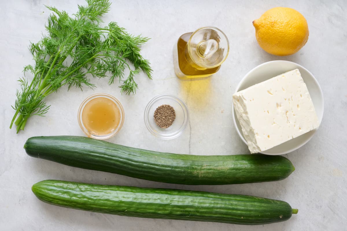 Ingredients for recipe: Cucumbers, feta cheese, olive oil, lemon, fresh dill, honey, black pepper.