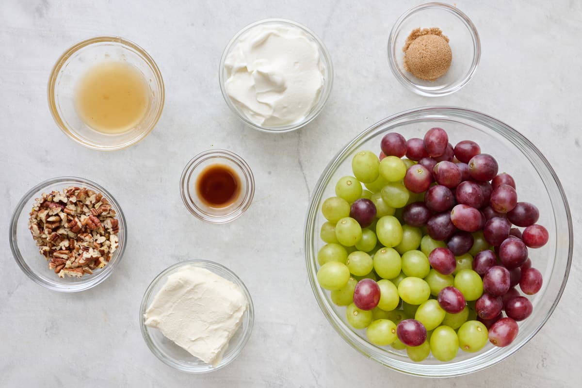 Ingredients for recipe: Red and green grapes, cream cheese, honey, Greek yogurt, vanilla extract, chopped pecans, and brown sugar.