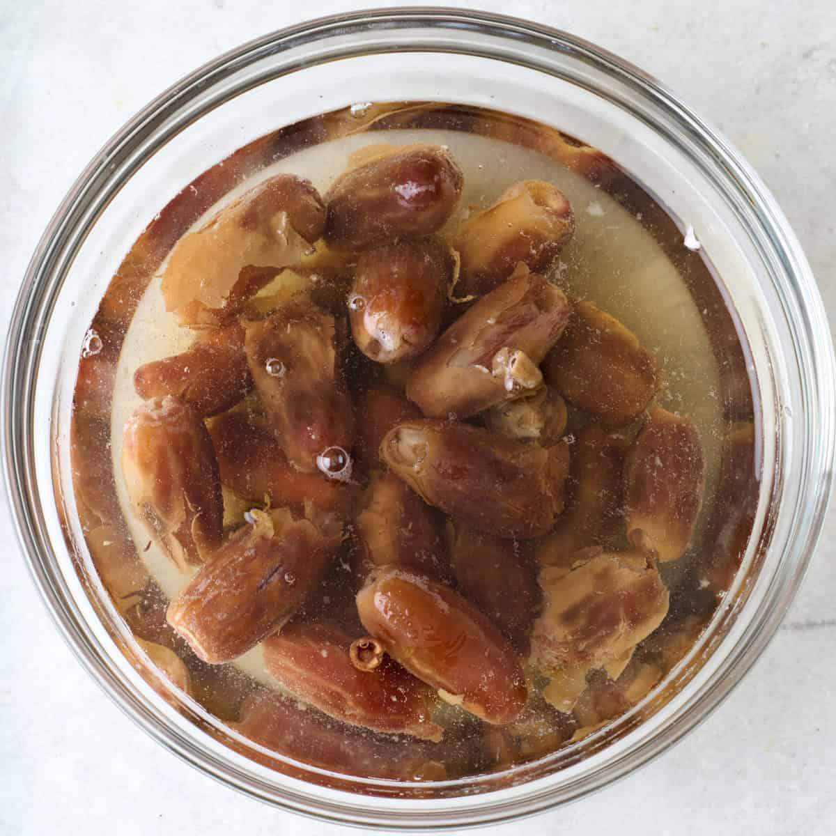 Dates in a bowl of water after soaking.
