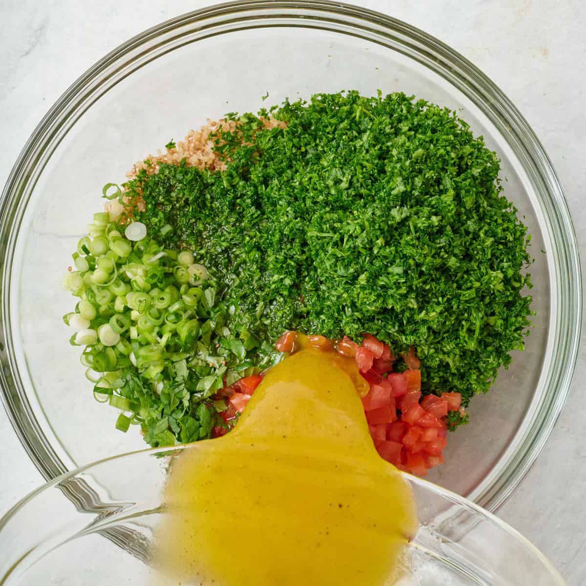 Pouring dressing over.