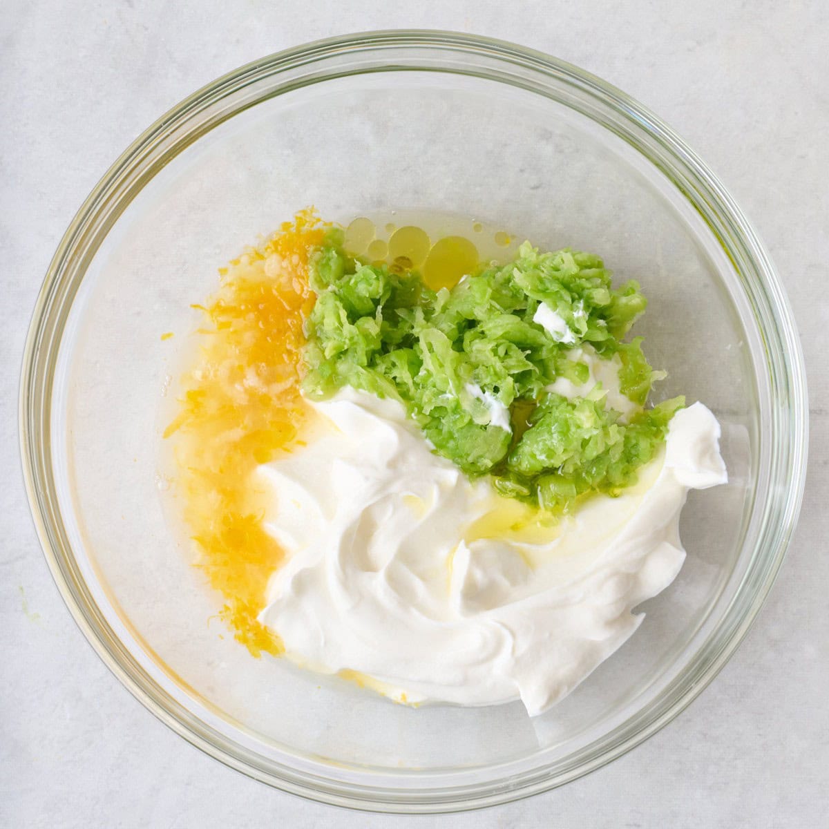 Tzatziki sauce ingredients in a bowl before combining.