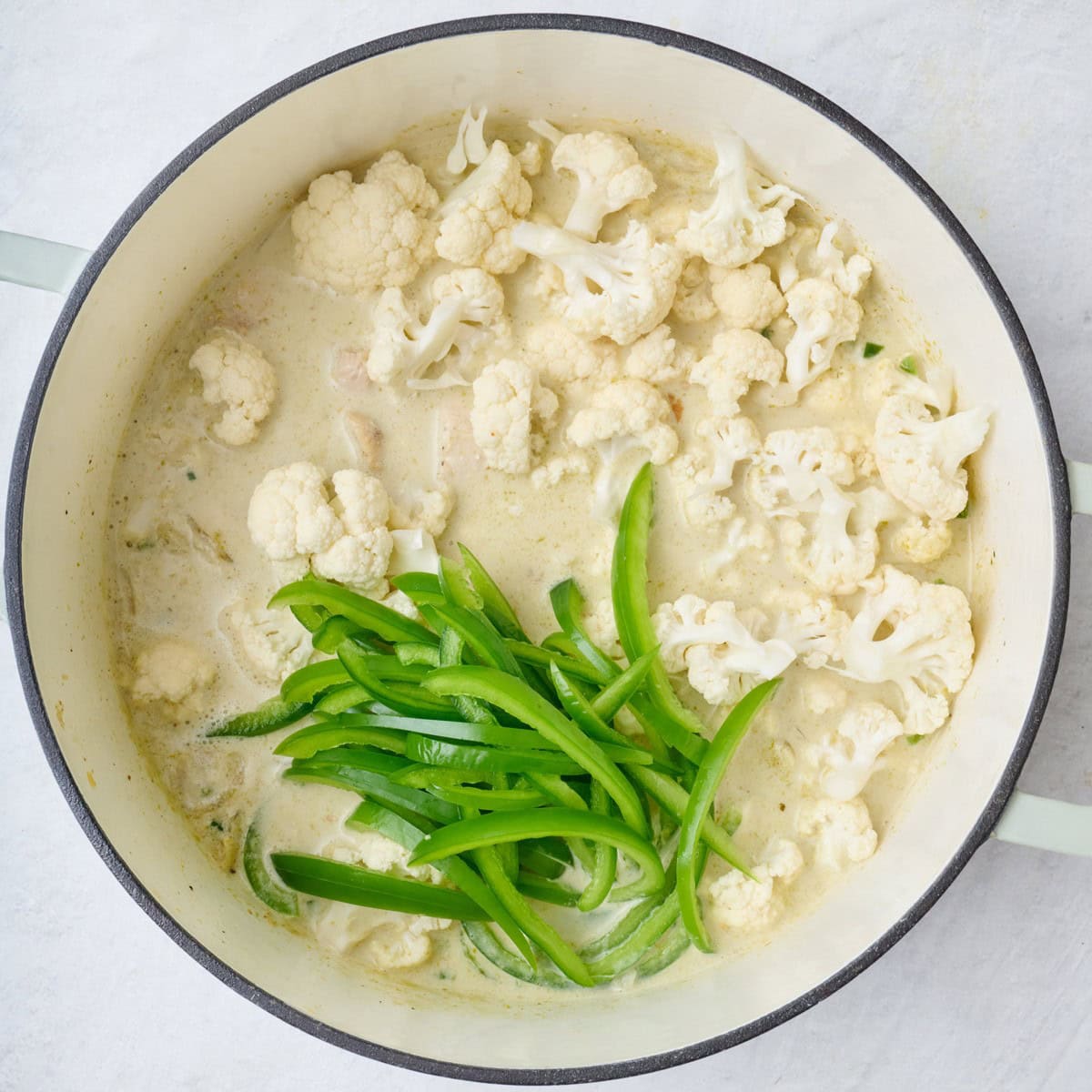 Green pepper, cauliflower, and chicken added to pot.