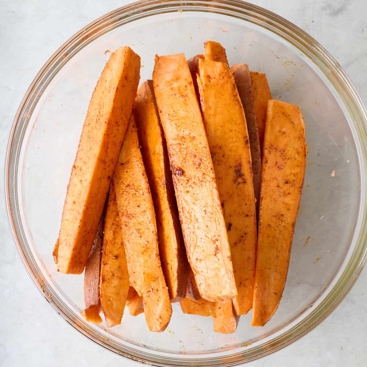 Spiced sweet potato wedges in a bowl.