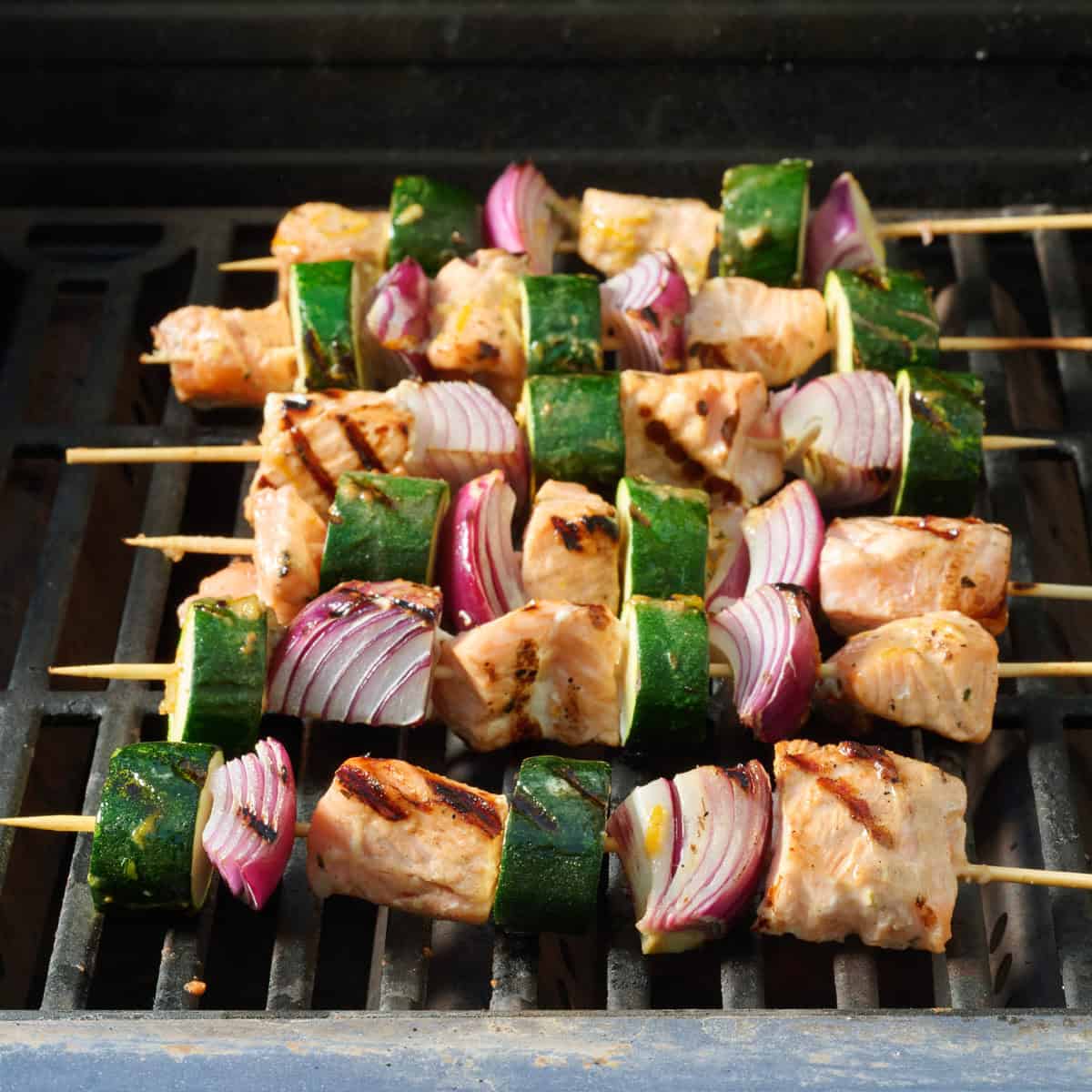 Salmon kabobs on a grill after cooking.