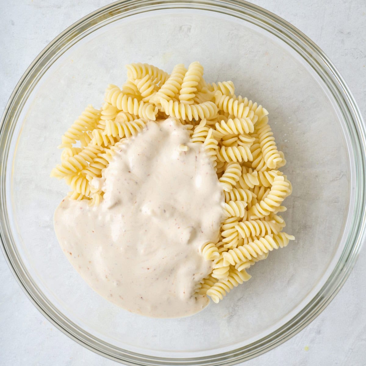 Dressing poured on top of the pasta.