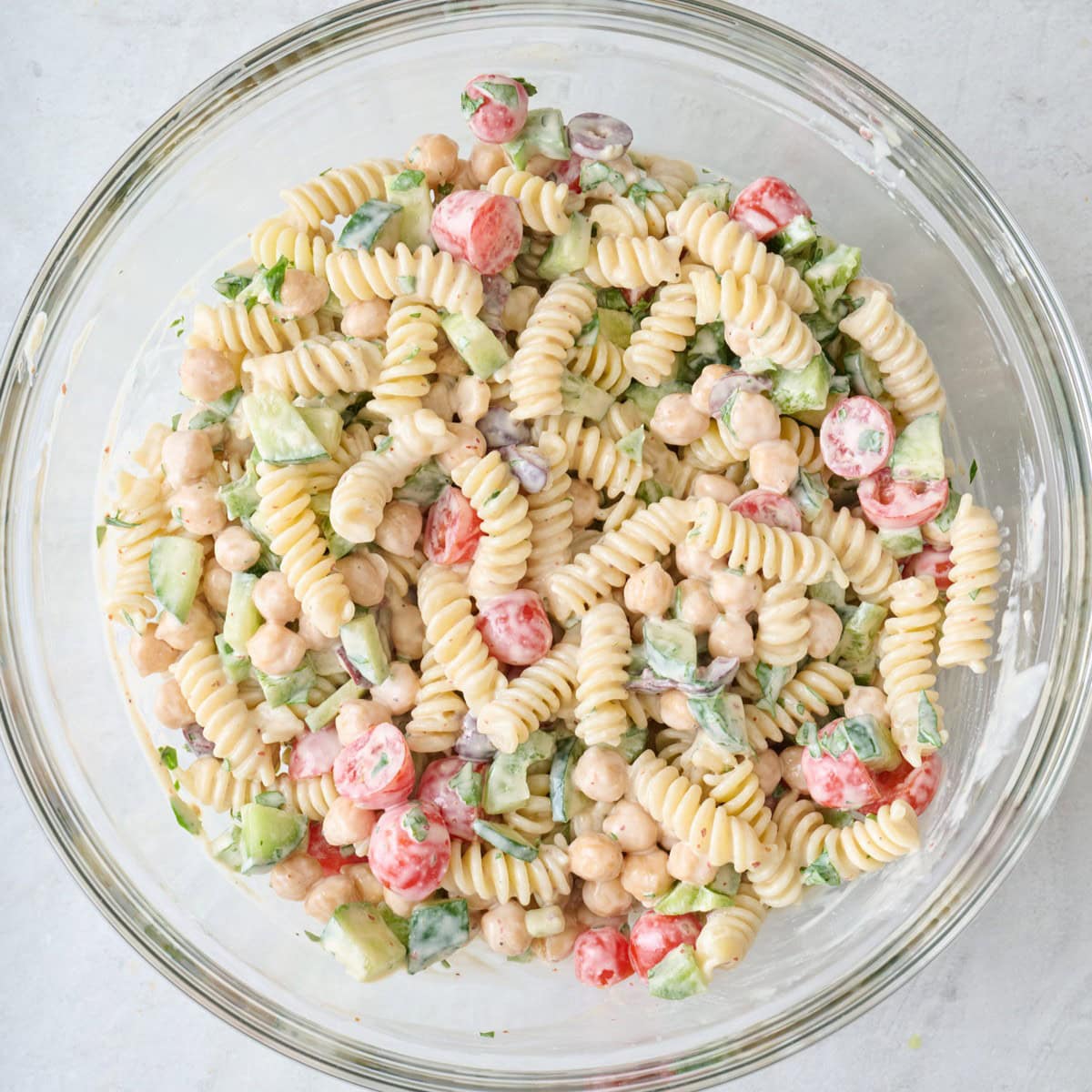 Fully combined pasta salad in a bowl.