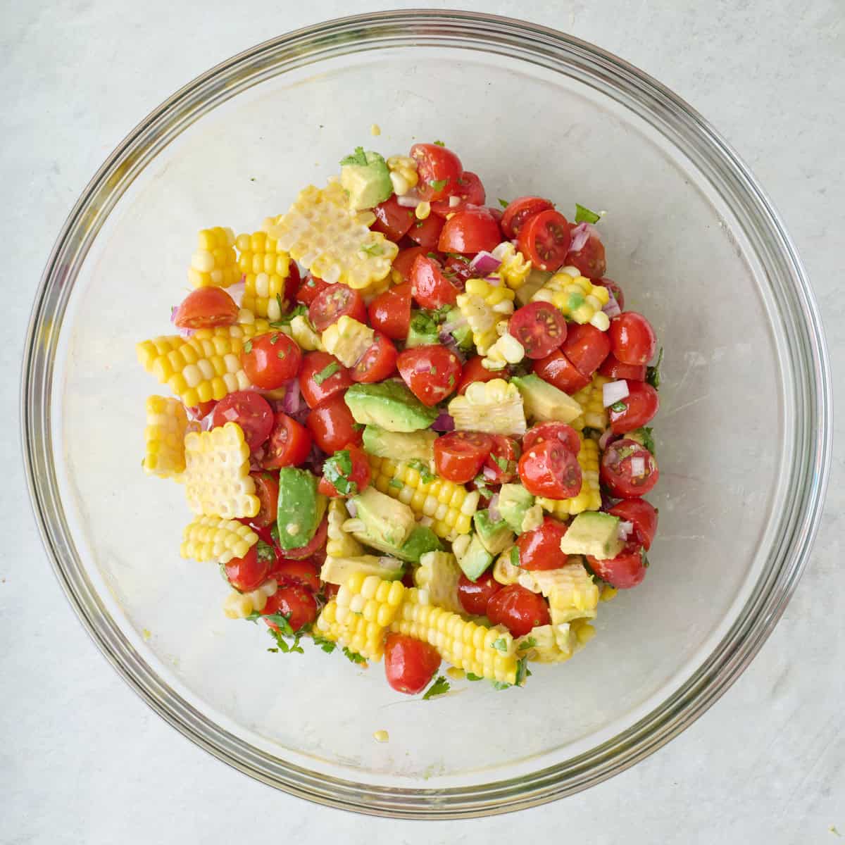 Corn tomato avocado salad in a large mixing bowl.