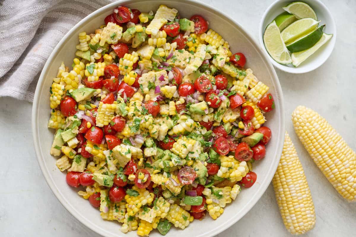 Corn tomato avocado salad in a large serving bowl.