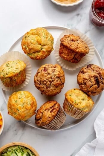 Two flavors of healthy muffins on a plate: zucchini and cheese, peanut butter and jam.