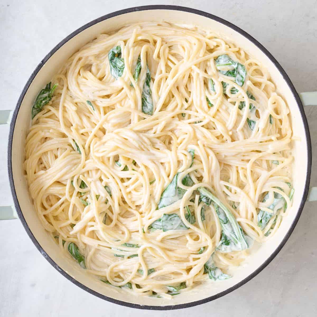 Lemon ricotta pasta with spinach in a pot.