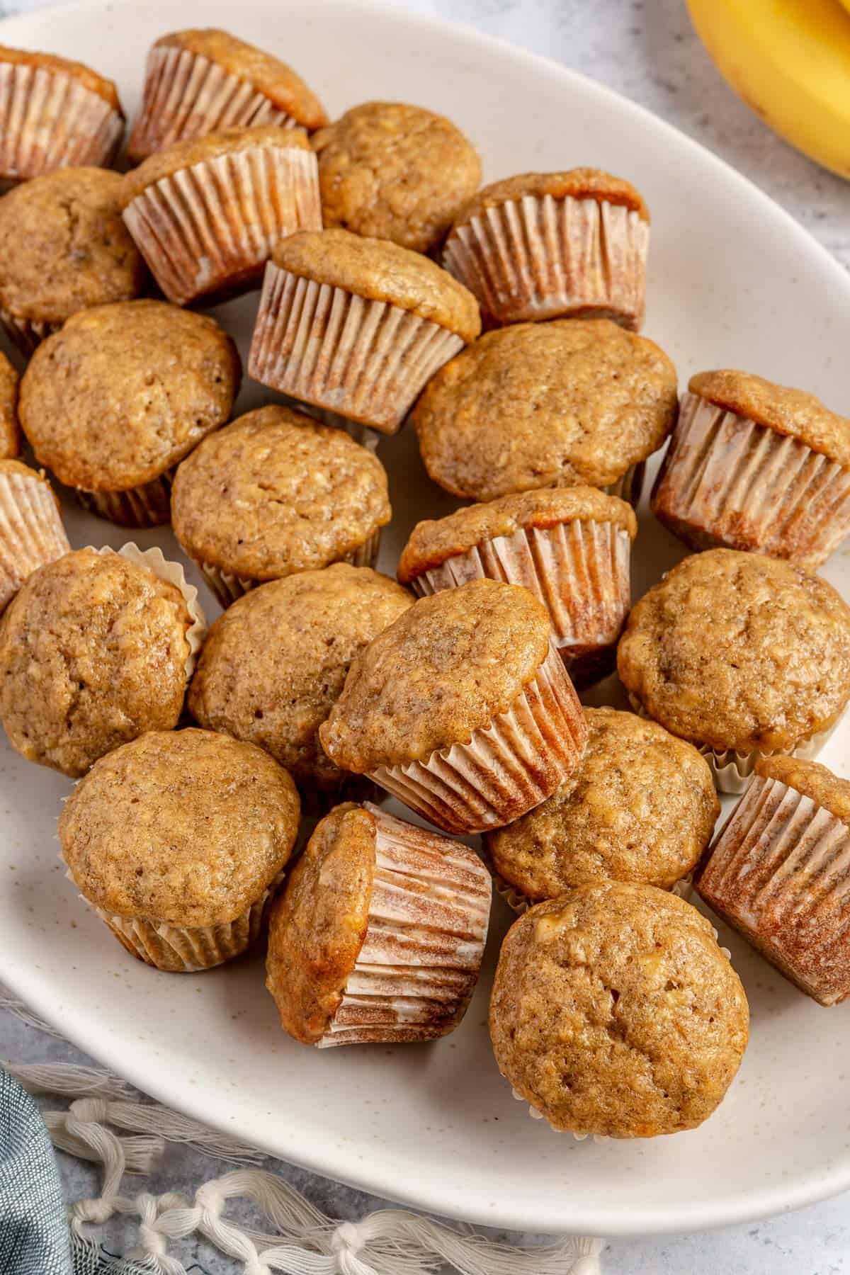 Mini banana muffins on a serving plate.