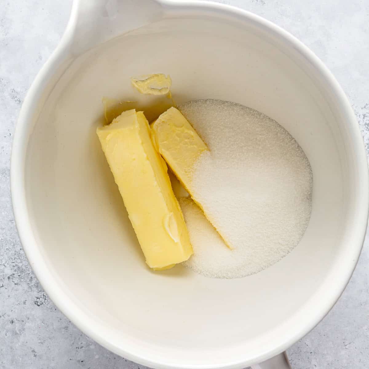 Butter and sugar in a mixing bowl.