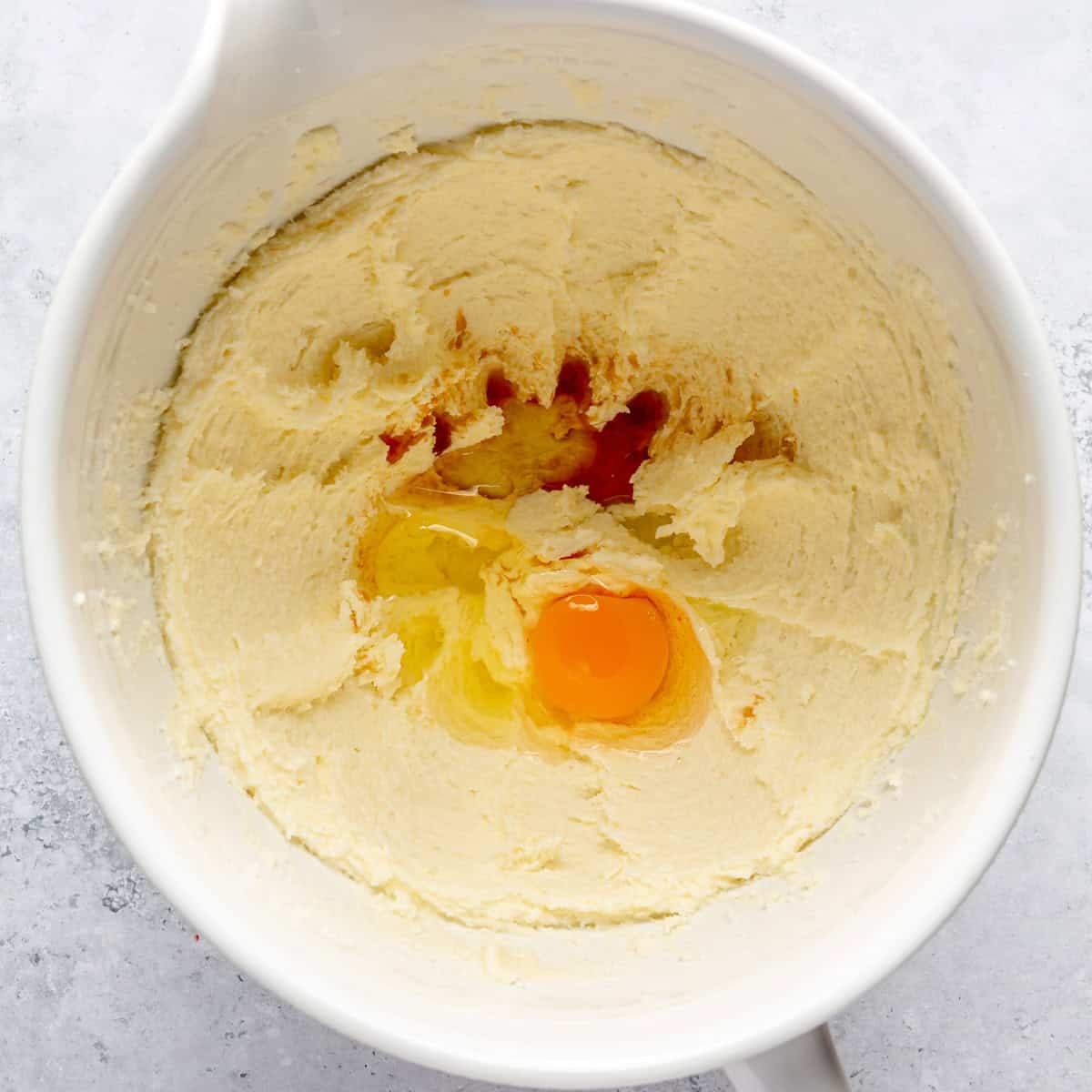 Creamed butter, sugar, vanilla, and egg in a mixing bowl.