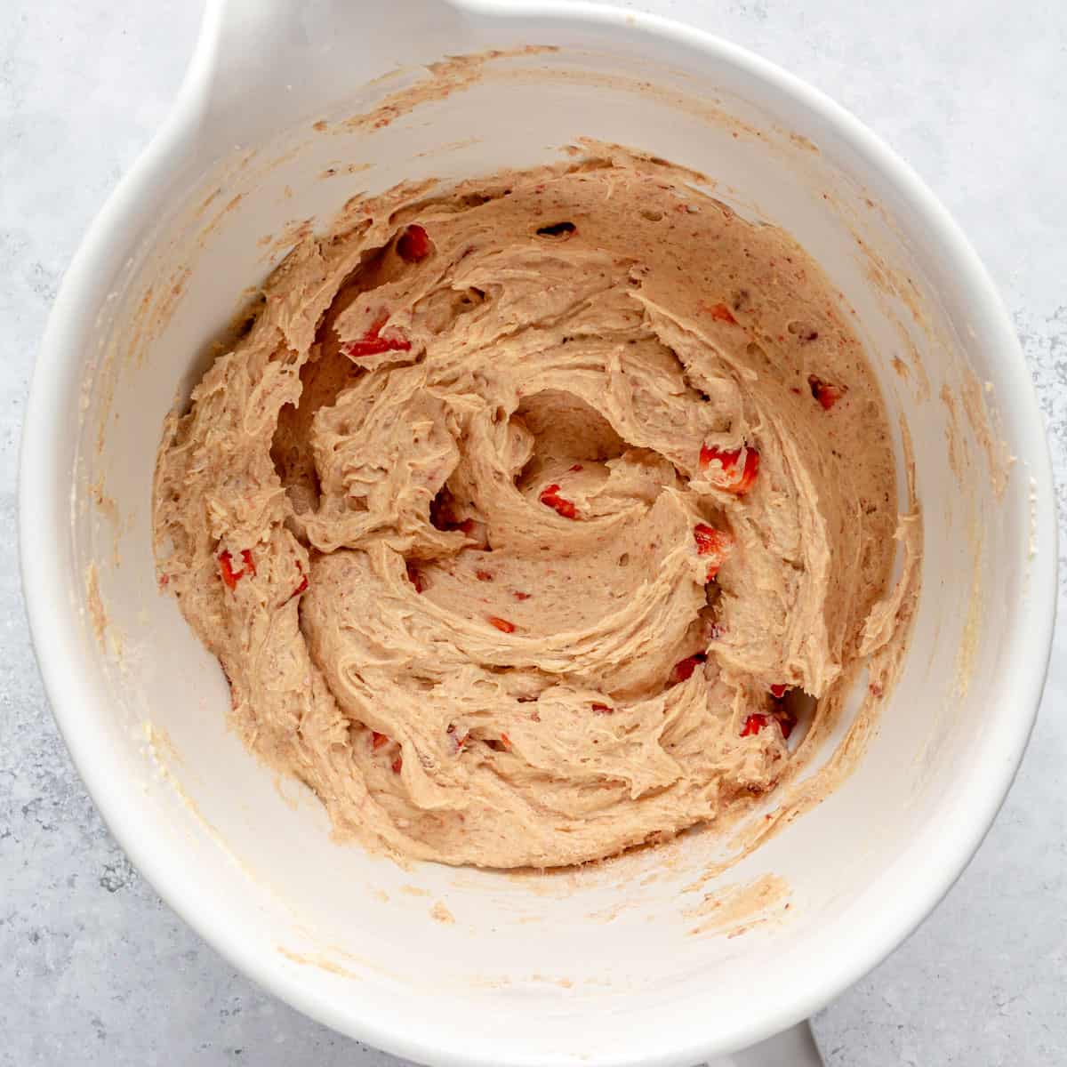 Strawberry pound cake batter in a ceramic mixing bowl.