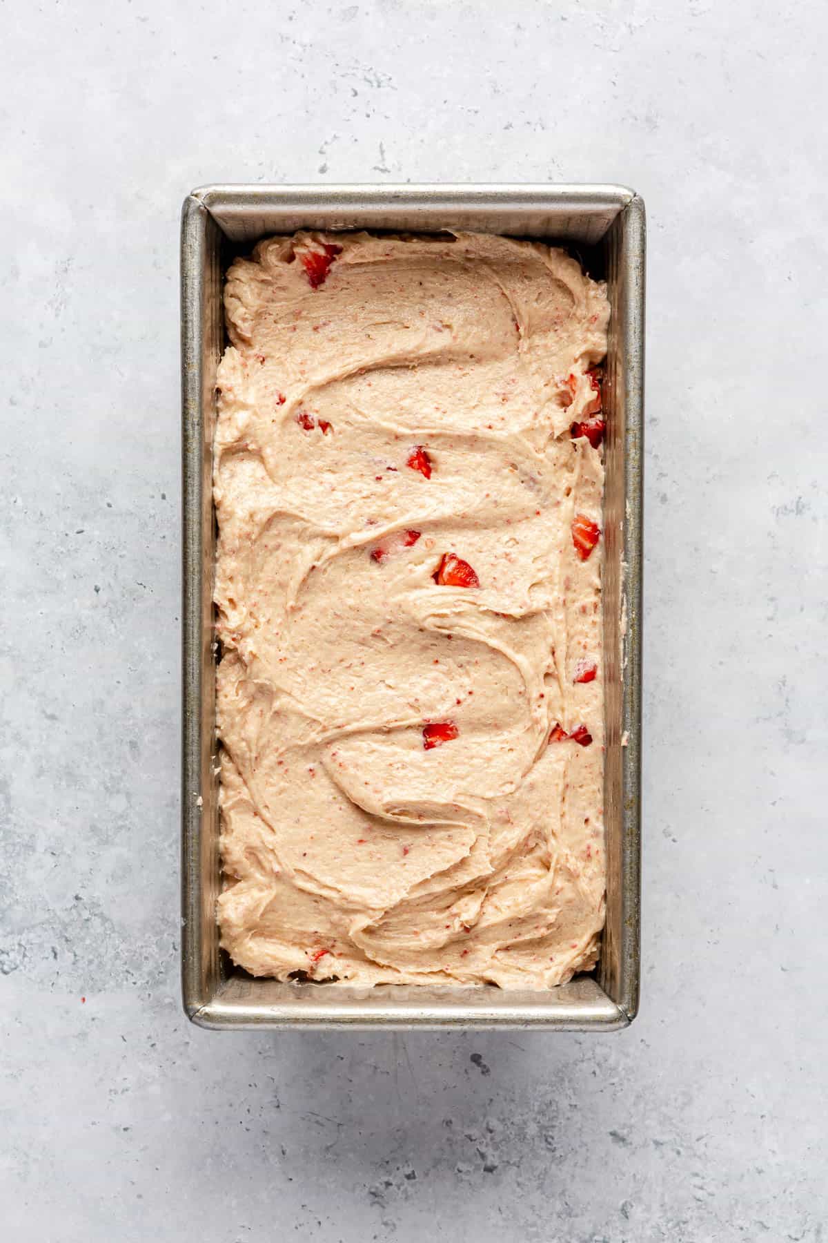 Strawberry pound cake batter in a loaf pan.