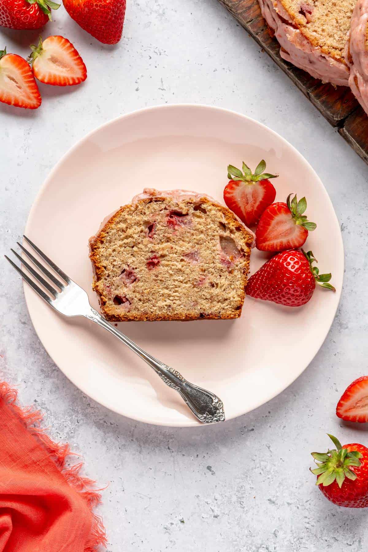 A slice of strawberry pound cake on a plate.