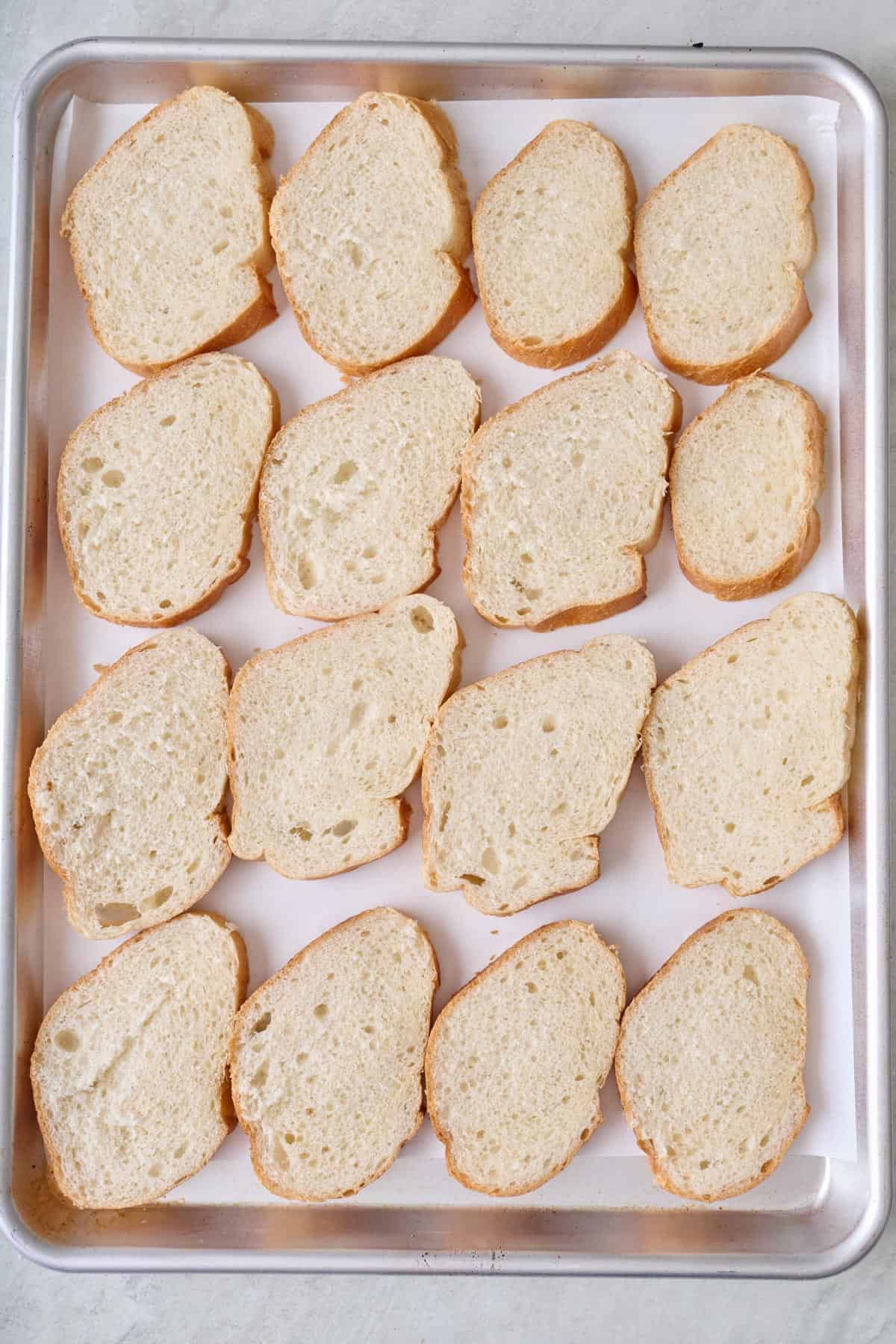 Pieces of bread on a sheet pan.