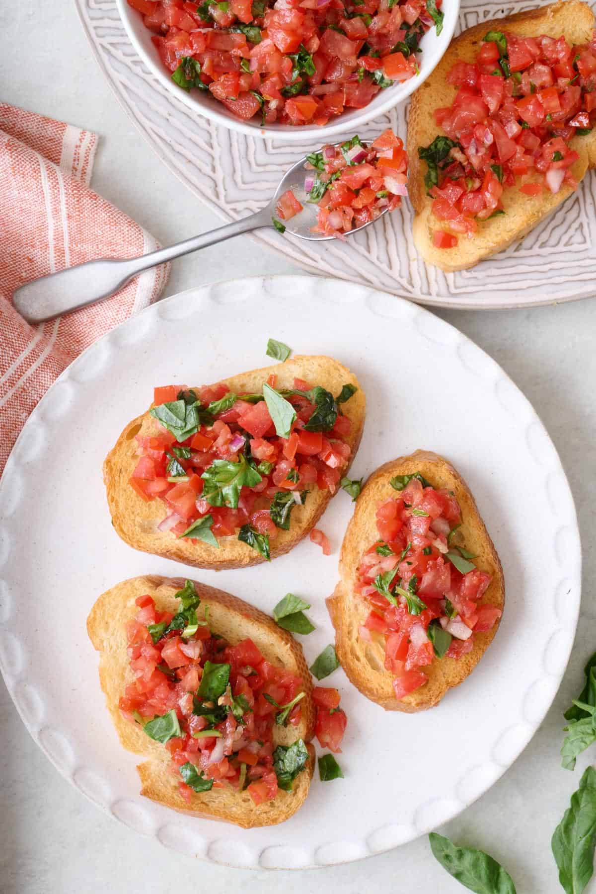 Pieces of toast topped with a tomato basil mixture.