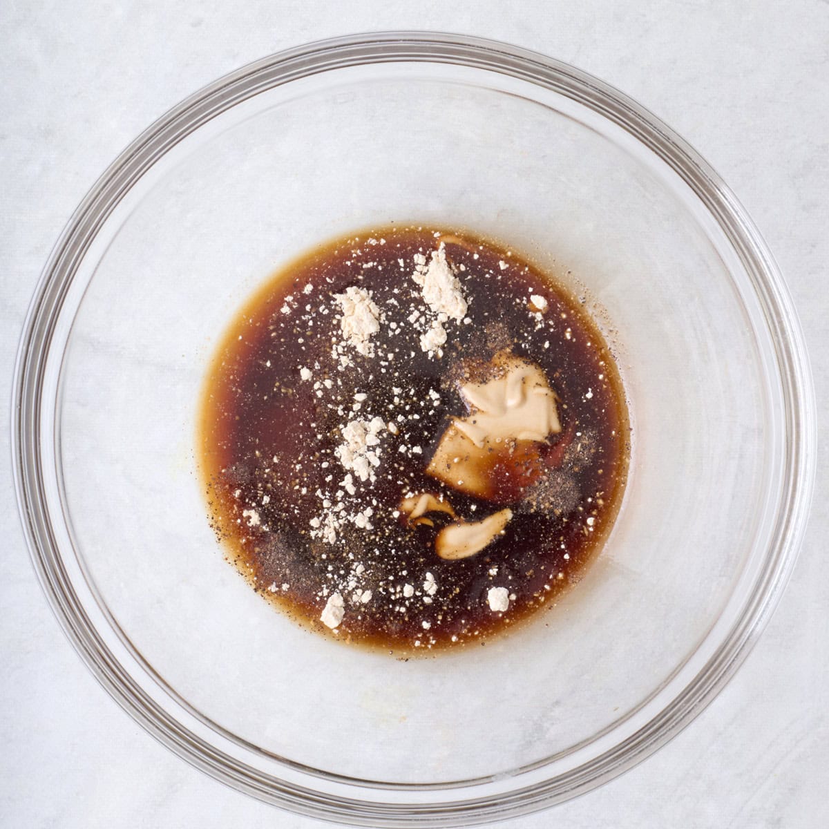 Dressing ingredients in a bowl before combining.