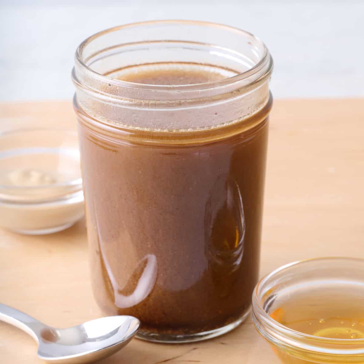 Homemade balsamic vinaigrette recipe in a small jar.