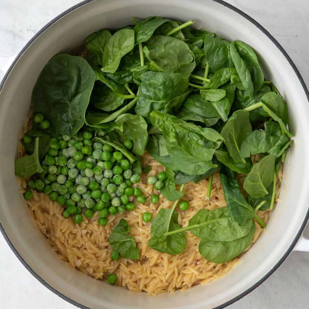 After cooked with spinach and peas added before combing.