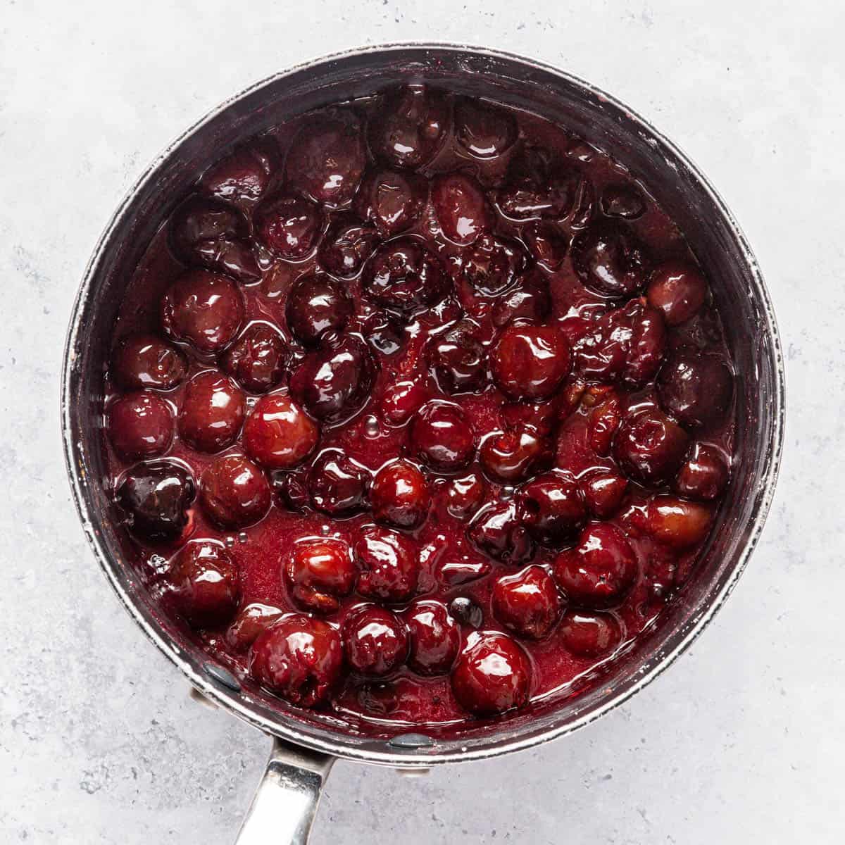 Cooked cherry pie filling in a saucepan.