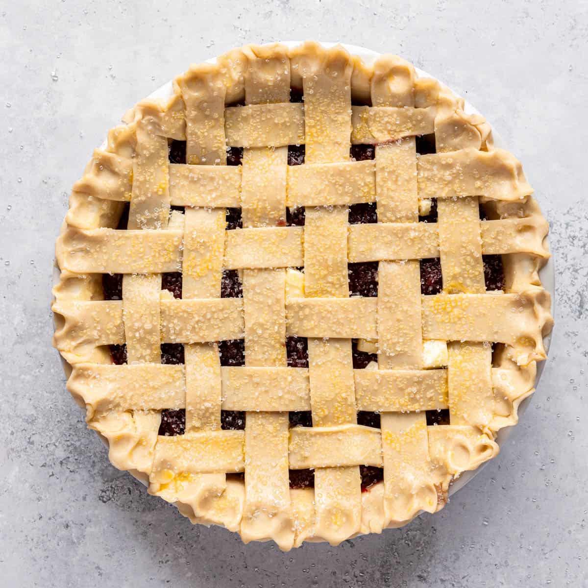 An unbaked cherry pie with a lattice crust.