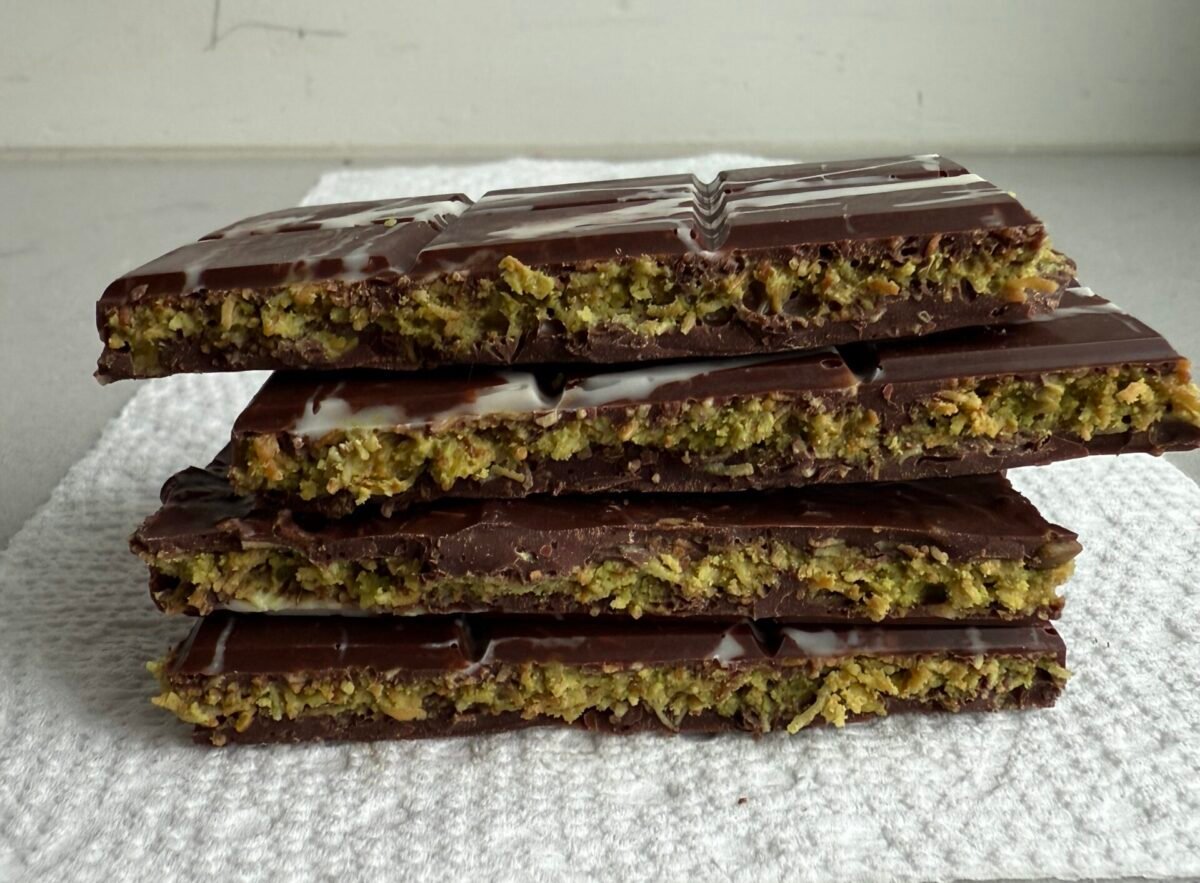 Stack of 4 cut Dubai Chocolate bars showing hte inside pistachio filling