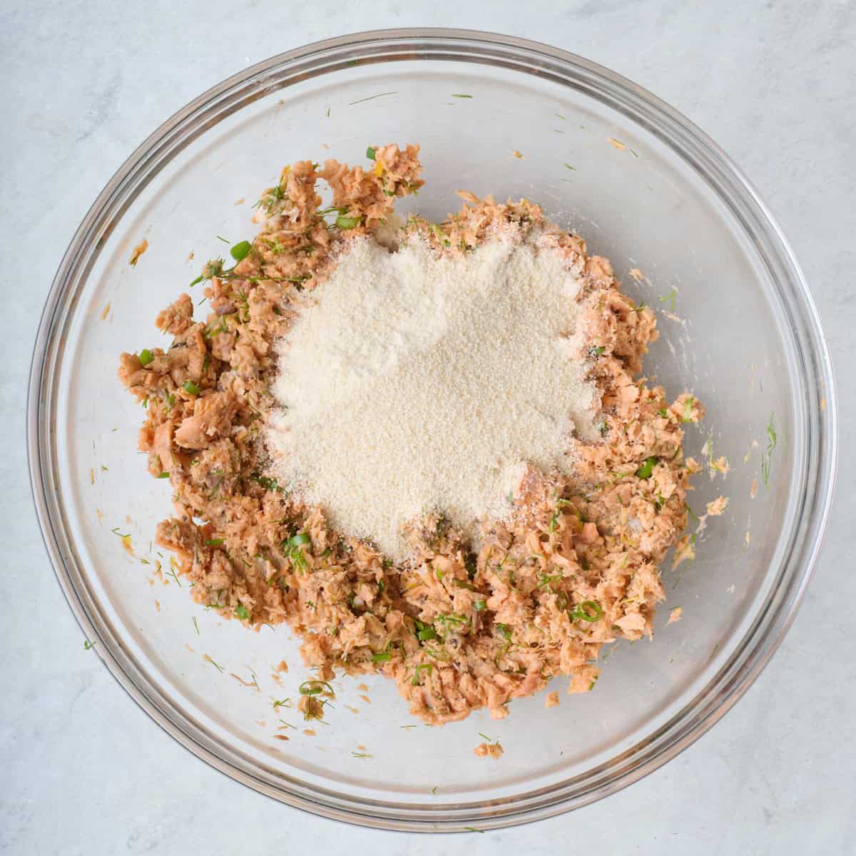 Salmon mixture with breadcrumbs added on top.