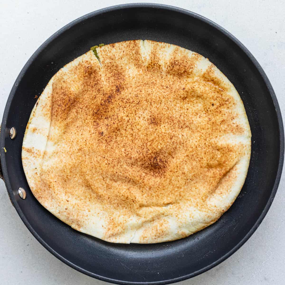 Pita face down in a skillet.