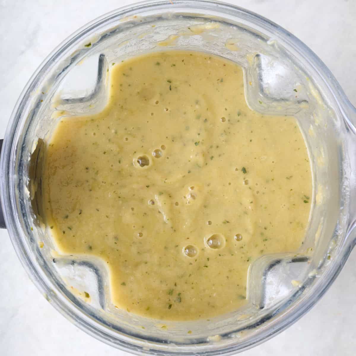 Blended zucchini soup in a blender jar.