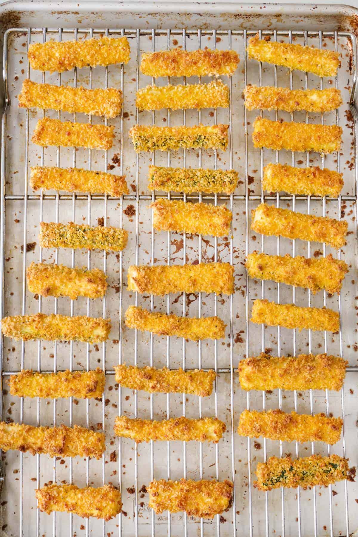 Crispy, browned zucchini fries on a baking sheet.