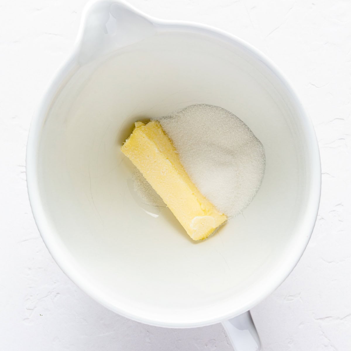 Butter and sugar in a mixing bowl.