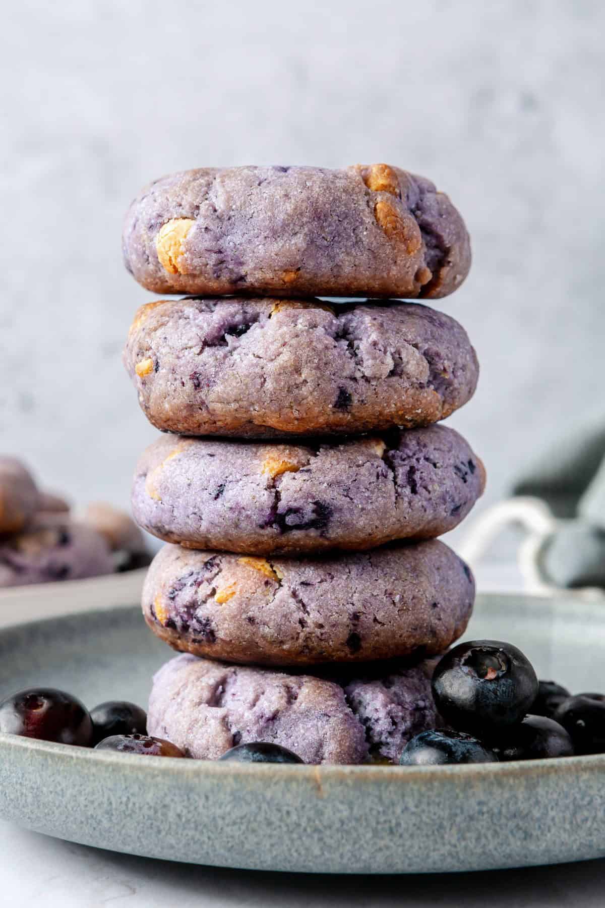 Stack of 5 blueberry cookies on a plate.