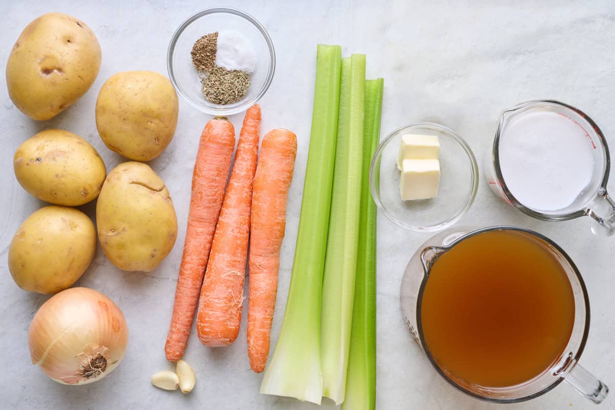 Ingredients for recipe: potatoes, onion, carrots, celery, seasoning, butter, milk, and broth.