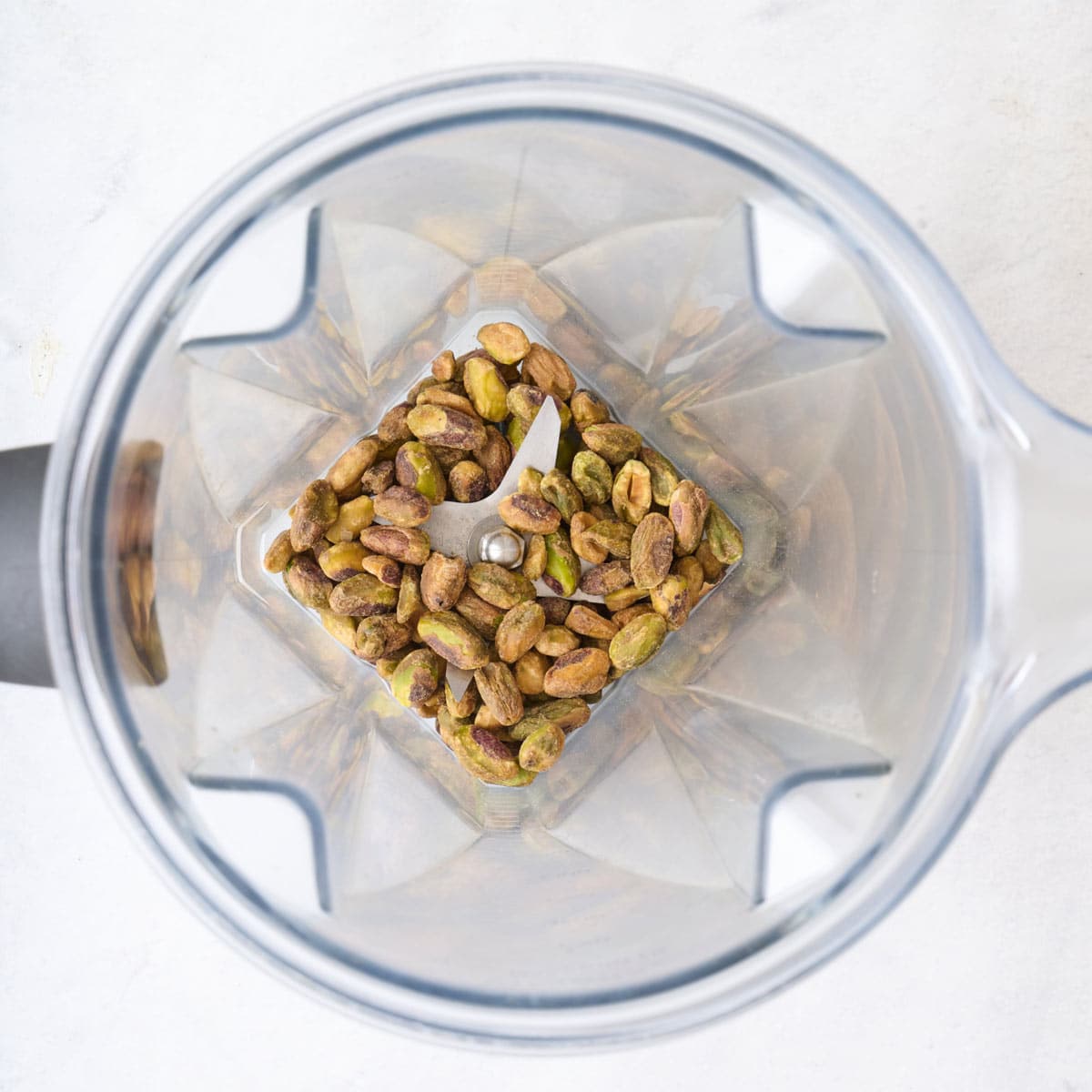 Pistachios in a food processor before processing.