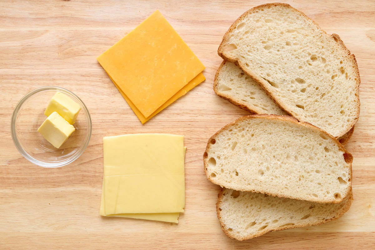 Ingredients for recipe: butter, 2 types of cheese, and bread slices.