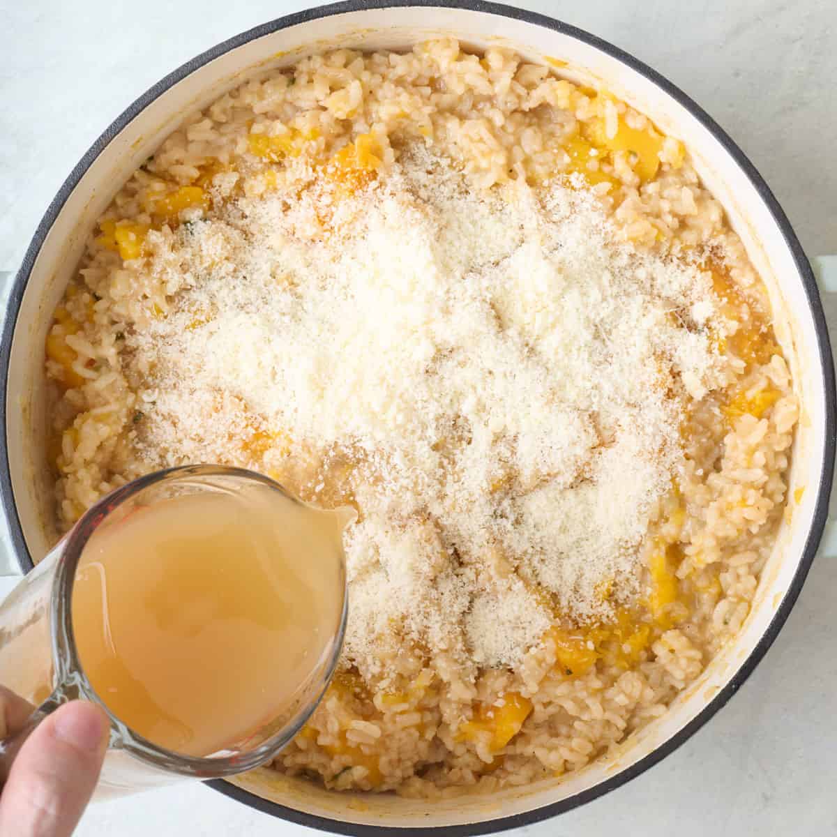 Broth and parmesan added to cooked rice.