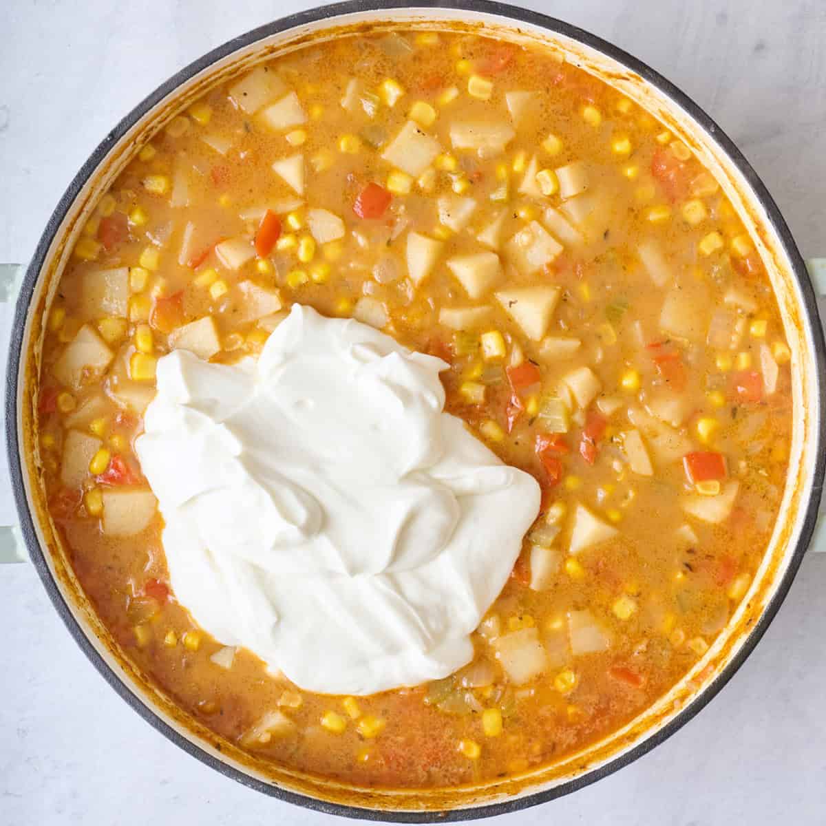 Greek yogurt added on top of soup in pot before blending.