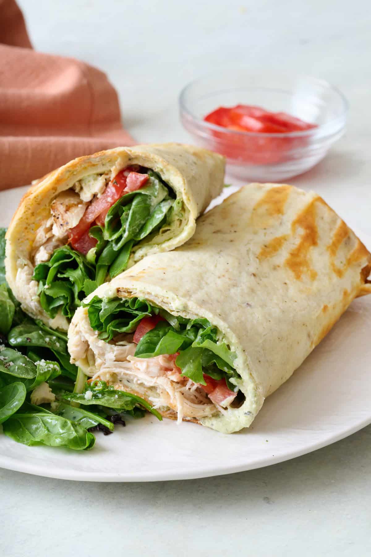 Cottage cheese flatbread rolled up and stuffed with chicken, tomatoes, and mixed greens.