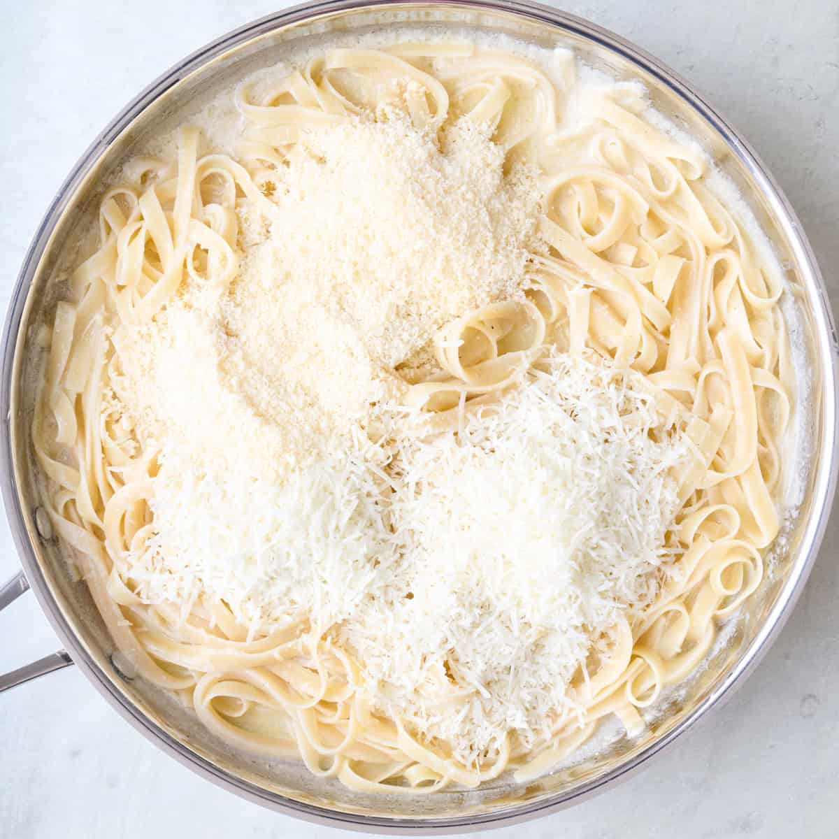 After coating pasta with grated cheeses added.