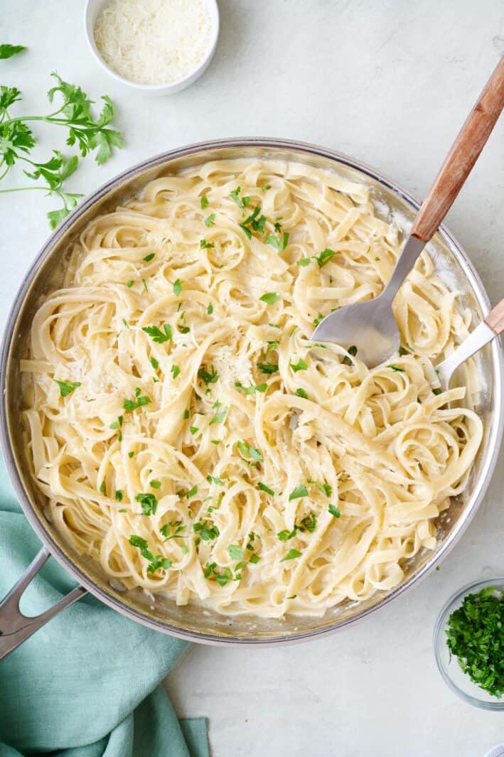 Homemade fettuccine alfredo in a skillet.