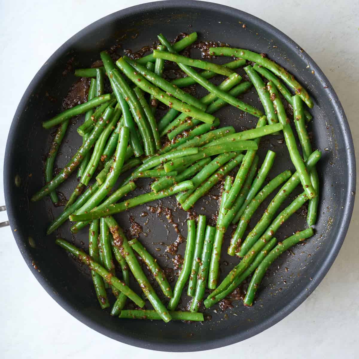 Green beans in a skillet after cooking.